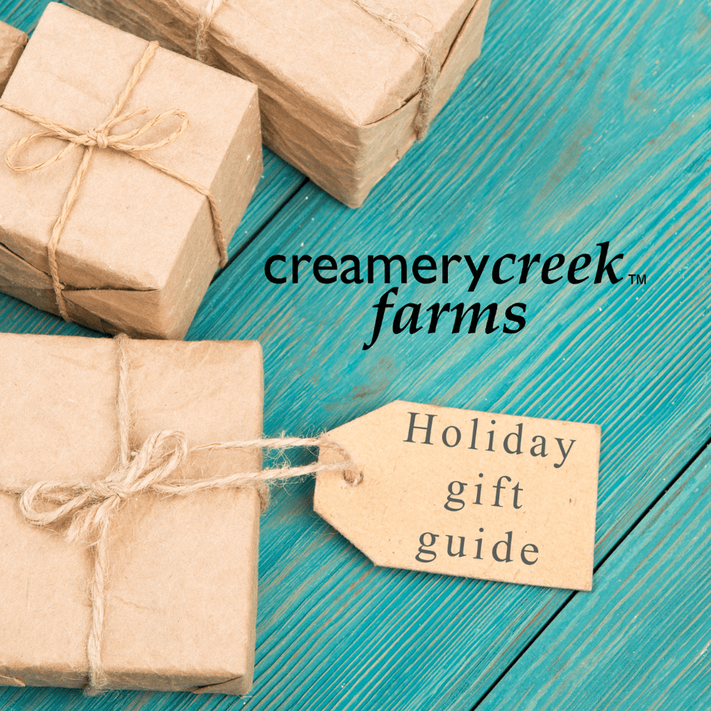 blue boards and cardboard paper wrapped gift for the creamery creek holiday gift guide