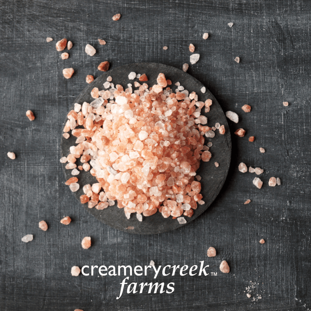 Himalayan Pink Salt coarse grind on a black background