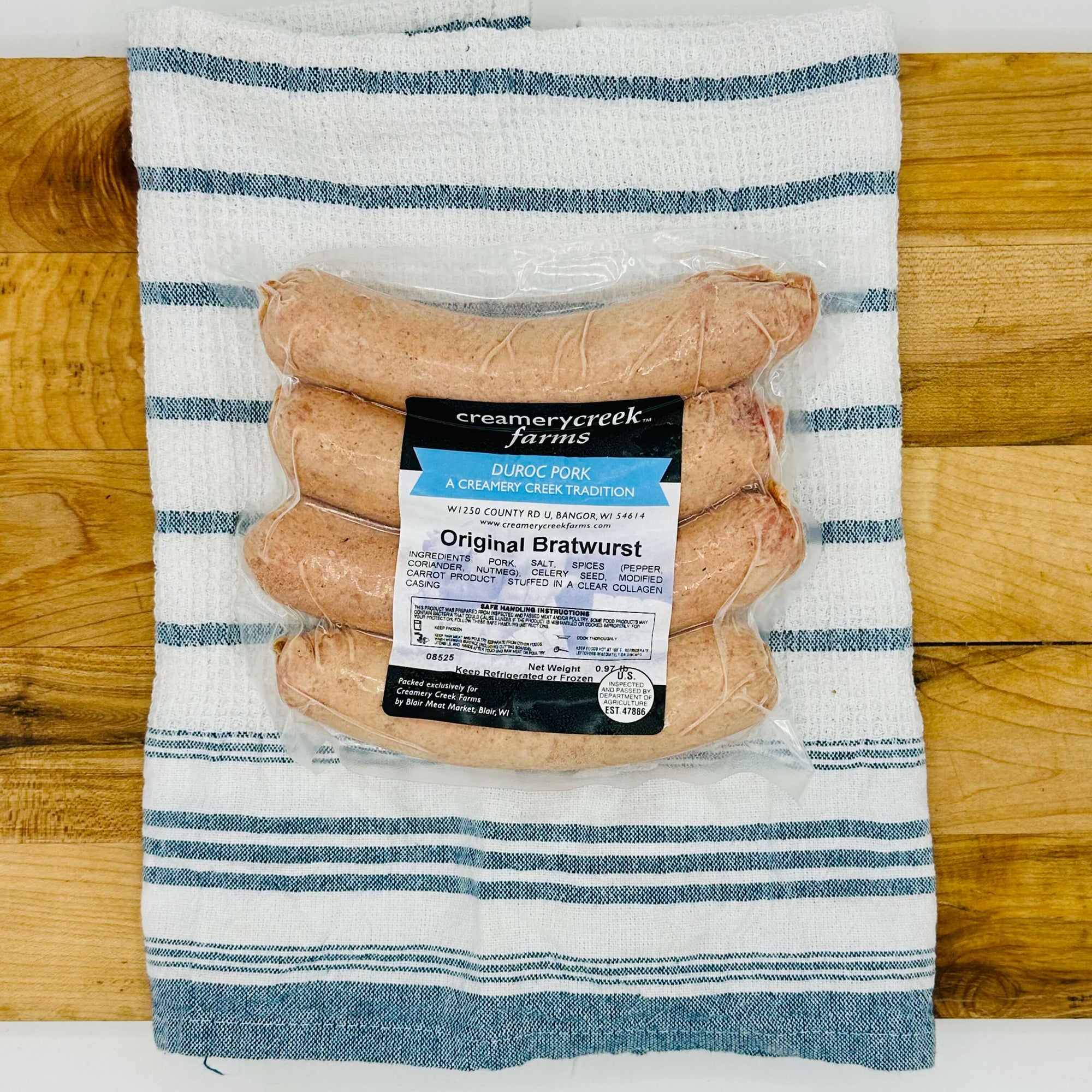 Four fresh Duroc pork bratwursts on a tray, uncooked and ready for the grill—extra-large size with natural marbling and clear collagen casing.