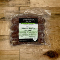 Packaged Farmhouse Bratwurst from Creamerycreek Farms on a wooden surface