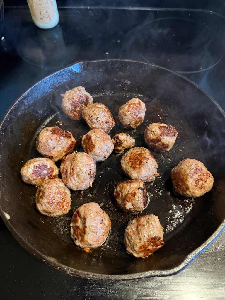browned meatballs in a skillet at Creamery Creek