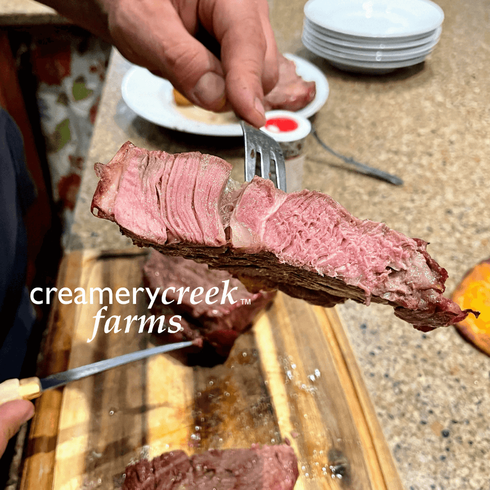 Justin holding a falling apart perfectly medium rare steak