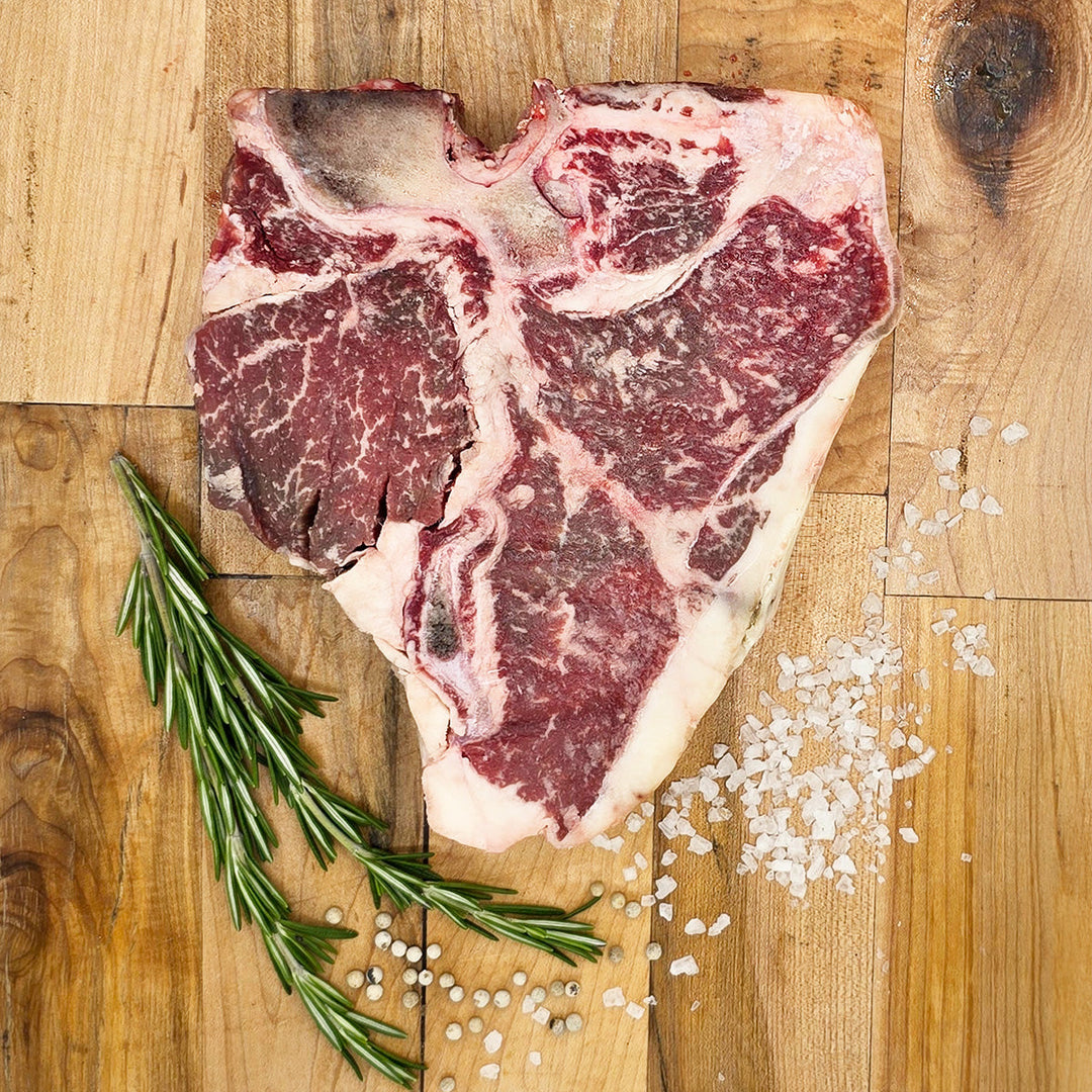 porterhouse shown on a cutting board, eating a steak raw isn't a great idea