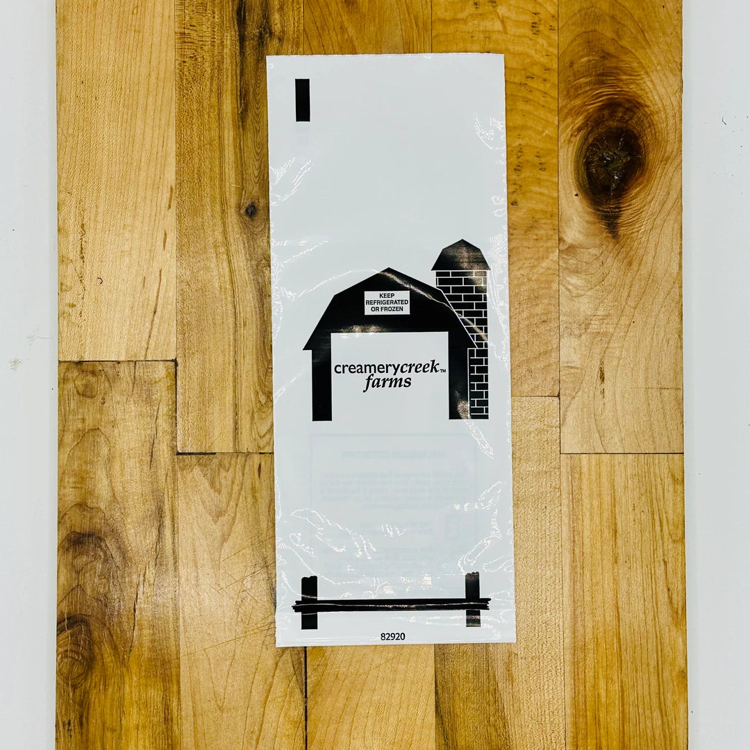 Plastic bag with 'Creamerycreek Farms' logo on a wooden surface