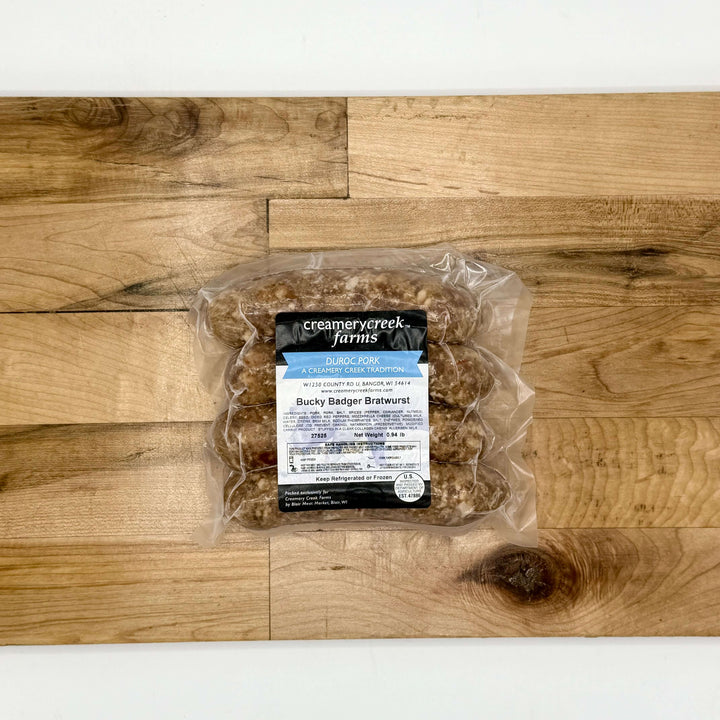 Packaged pork bratwurst product on a wooden surface with &