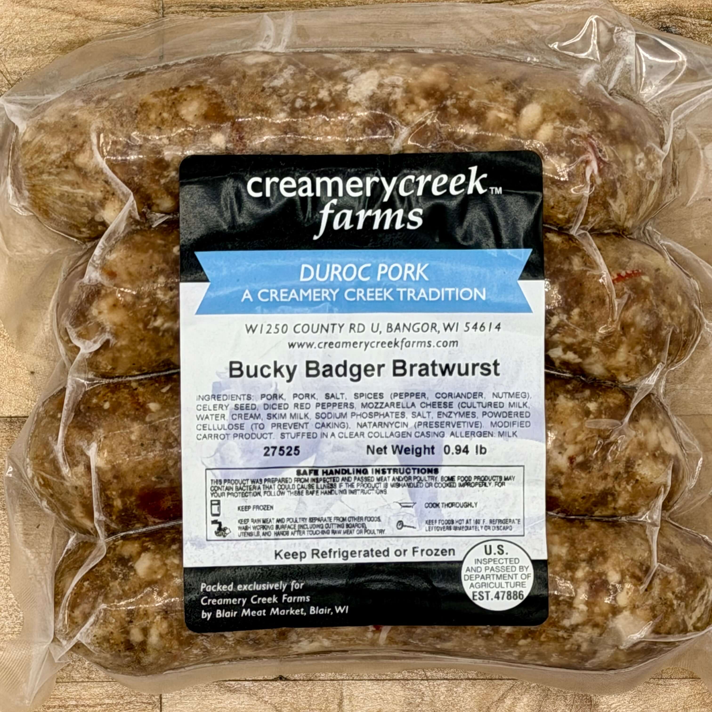 Bucky Badger Bratwurst package with Creamery Creek Farms label on a wooden surface