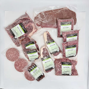 Assorted packages of ground beef and other meat products on a white background