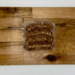 Packaged sausages on a wooden surface