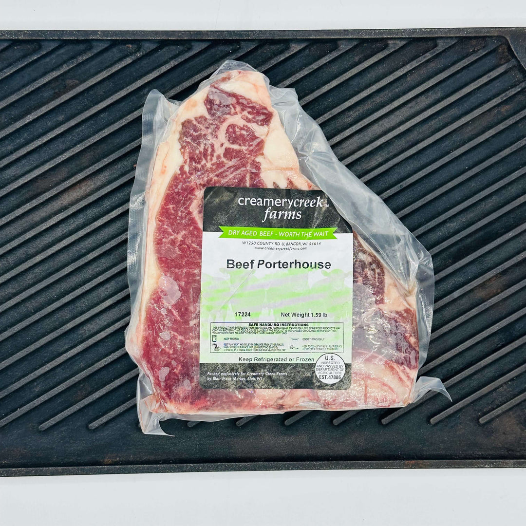 Packaged beef porterhouse on a grill grate at Creamery Creek