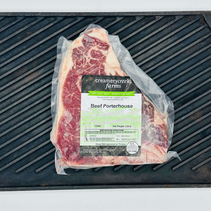 Packaged beef porterhouse on a grill grate at Creamery Creek
