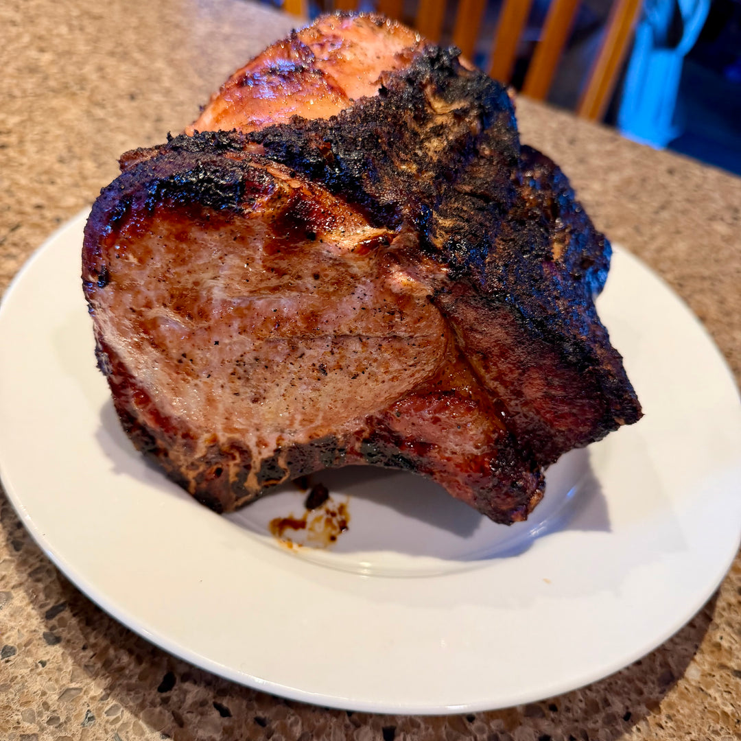 Grilled pork loin on a white plate with a blurred background