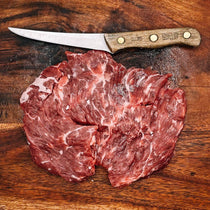 Dry Aged Beef Skirt Steak from Creamery Creek Farms next to knife