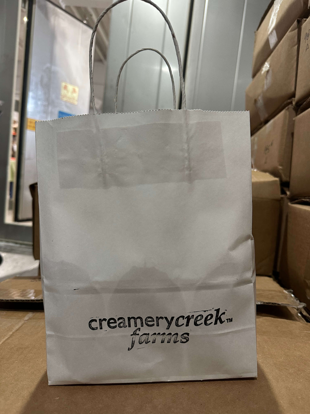White paper bag with &