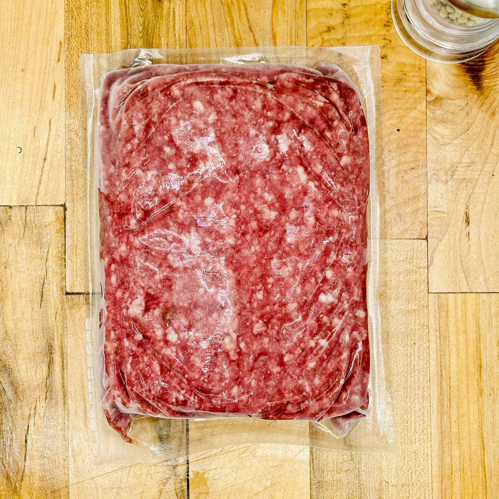 Packaged ground meat on a wooden surface