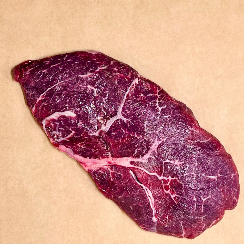 top sirloin steak on brown paper