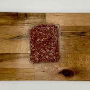 Packaged ground meat on a wooden surface