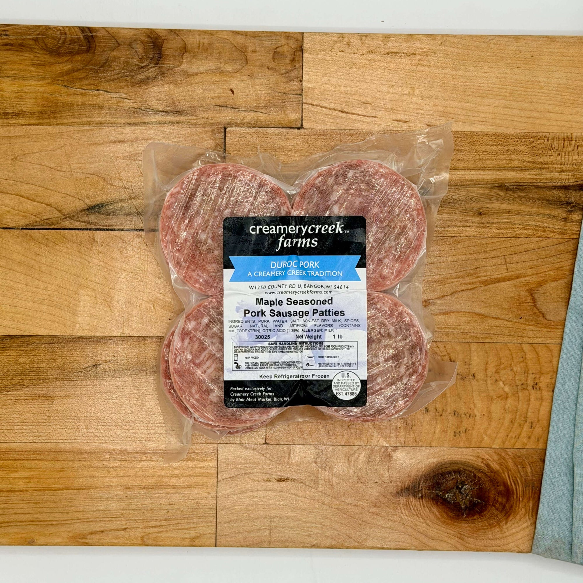 Packaged Maple Seasoned Pork Sausage Patties from Creamerycreek Farms on a wooden surface