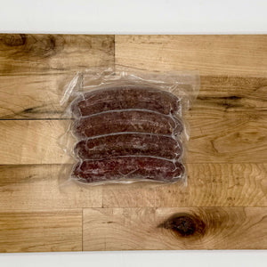 Packaged sausages on a wooden surface