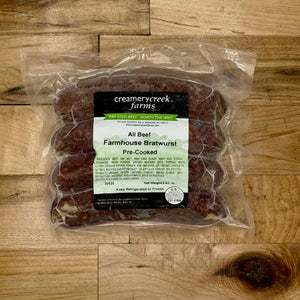 Packaged Farmhouse Bratwurst from Creamerycreek Farms on a wooden surface