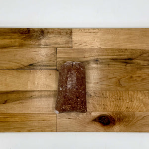 Meatball mix chub on a wooden surface