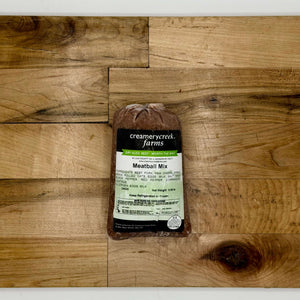 Packaged meat mix from Creamery Creek Farms on a wooden surface