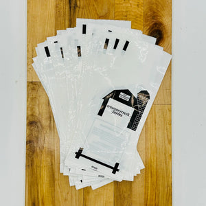 Stack of clear plastic bags with printed designs on a wooden surface