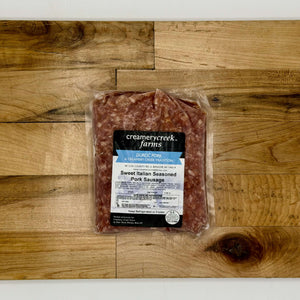 Packaged sweet Italian seasoned pork sausage from Creamerycreek Farms on a wooden surface
