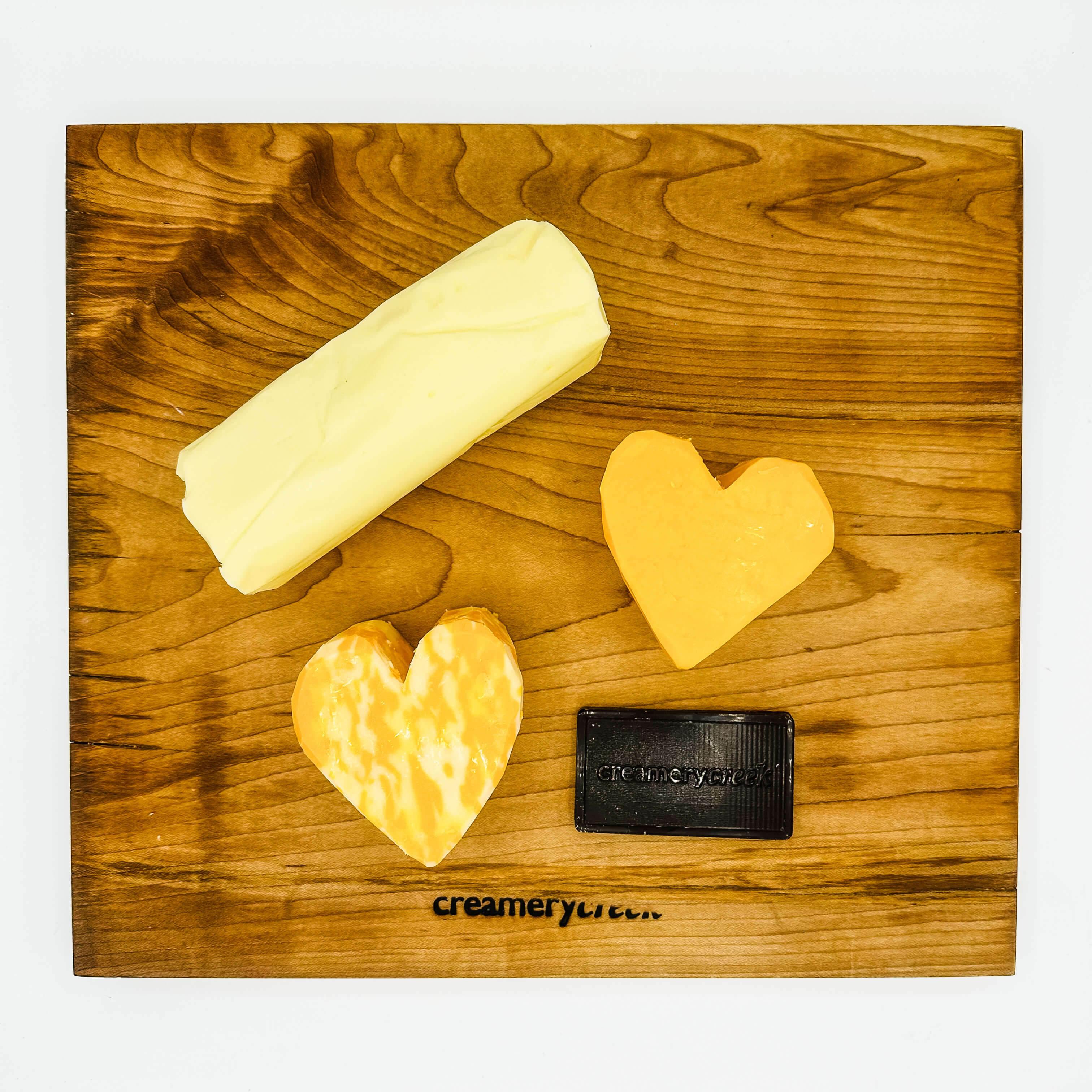 Wisconsin butter cheese and chocolate on a creamerycreek cutting board
